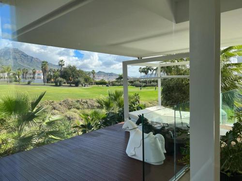 an open porch with a view of a golf course at Luxury Villa Rebeka - Heated Pool and Jacuzzi in Adeje