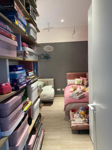 a childs room with a bed and a shelf with books at Luxury Villa Rebeka - Heated Pool and Jacuzzi in Adeje