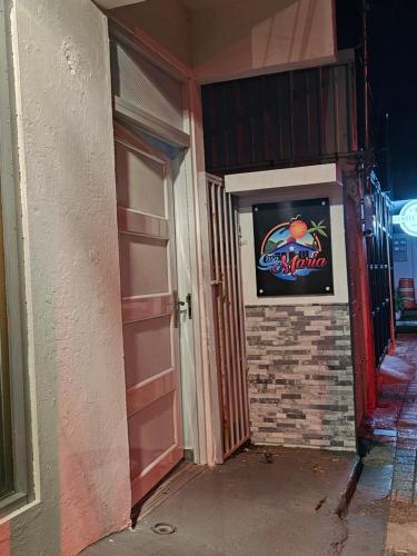 a door to a building with a sign on it at Casa Maria Luquillo PR in Luquillo