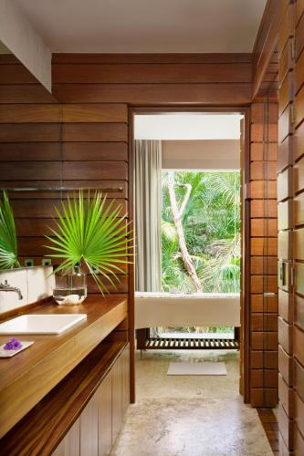 a bathroom with a sink and a window at Chablé Yucatan in Chocholá