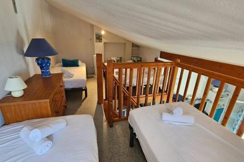 En eller flere senge i et værelse på Maison 5 personnes côté plage