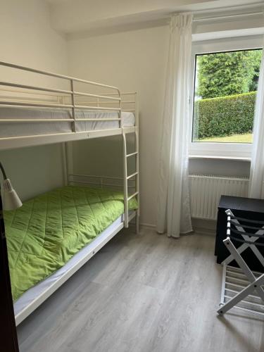 a bedroom with two bunk beds and a window at Familienglück im Odenwald in Grasellenbach