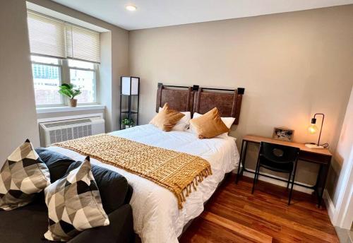 a bedroom with a large bed and a table at 402 Stylish luxe Apt at center city self check-in in Philadelphia