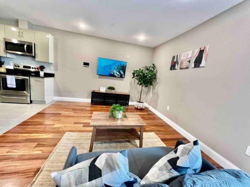 a living room with a couch and a table at 402 Stylish luxe Apt at center city self check-in in Philadelphia