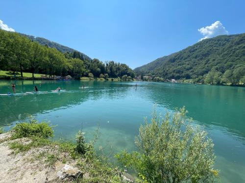 a lake with people in boats on the water at Apartment & Studio Forest Paradise in Cerkno