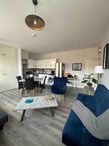 a living room with blue chairs and a table at Central 2-bed Apartment in Dublin