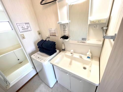 a bathroom with a sink and a washing machine at Sapan Hasegawa - Vacation STAY 14781 in Kitakyushu