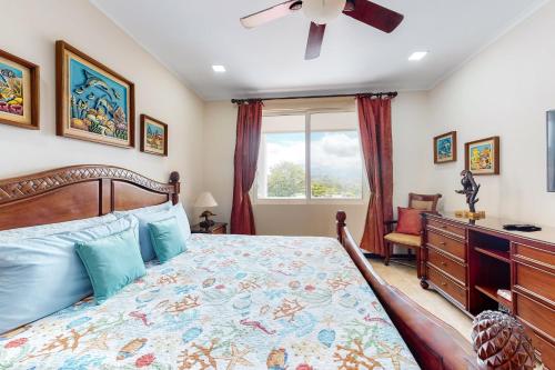 a bedroom with a bed and a dresser and a window at The Palms 603 in Jacó