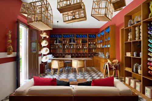 a living room with red walls and a couch at Chablé Yucatan in Chocholá