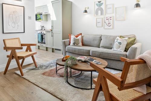 a living room with a couch and a table at Cosy & Bright Home with Backyard in Southsea Portsmouth in Portsmouth