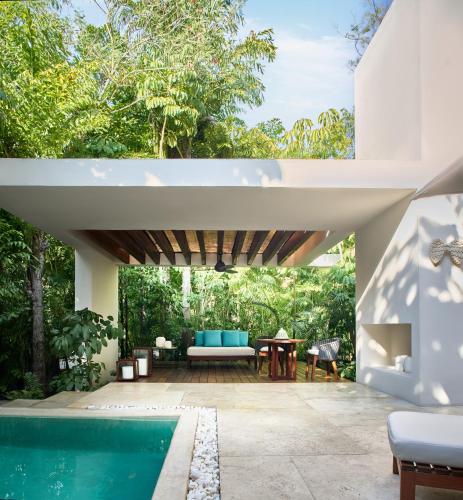 an outdoor patio with a swimming pool and a house at Chablé Yucatan in Chocholá