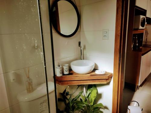 a bathroom with a sink and a mirror at Morada Héstia in Imbé