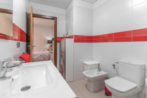 a bathroom with a white toilet and a sink at CASA ANA in Alcalá