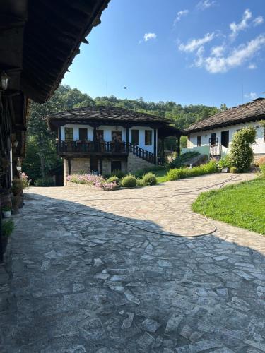 a cobblestone driveway in front of a house at FarFar Hideaway in Tryavna