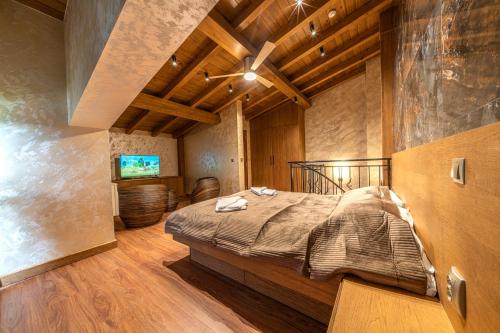 a bedroom with a bed and a television in it at Pirin Golf Hotel&Spa Apartment 17 - private luxury apartment in Razlog