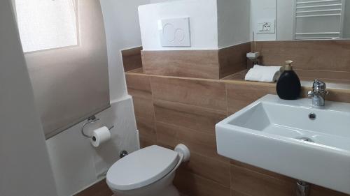 ein Badezimmer mit einem weißen WC und einem Waschbecken in der Unterkunft Dimora Chiara 