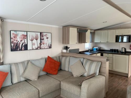a living room with a couch and a kitchen at Hot tub breakaways with castle view in Lincolnshire