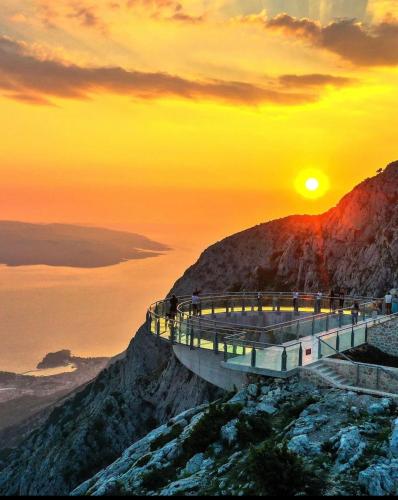 a bridge on top of a mountain at sunset at Ellamar City Center Apartment in Makarska