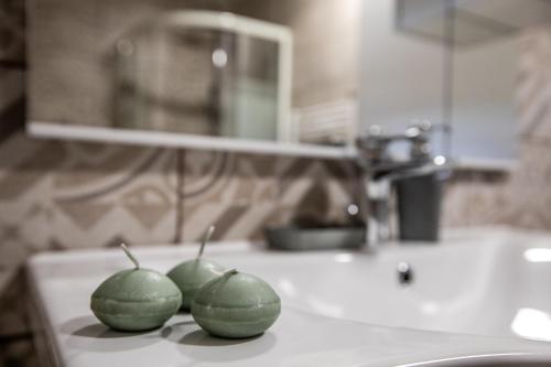 two green peppers sitting on top of a kitchen counter at Apartman Mila in Josipdol
