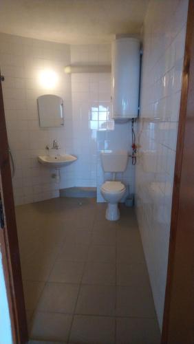 a bathroom with a toilet and a sink at Къща за гости Уют in Sveti Vlas