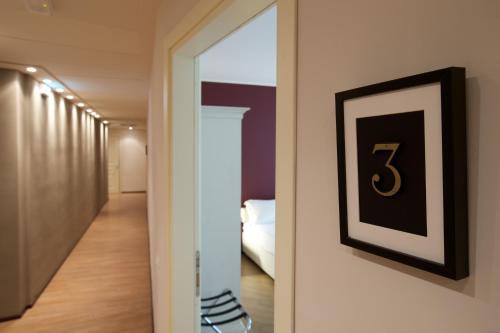 a hallway with a number six on a wall at Hotel Leon D'Oro in Mantova