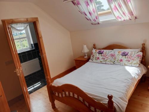 a bedroom with a wooden bed and a mirror at Willowfarmhouse in Milford