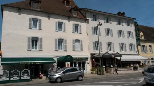 a small car parked in front of a building at Hôtel de La Cloche in Dole