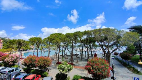 a parking lot with cars parked next to a body of water at UN BALCONE IN PINETA in Fezzano