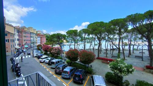 a row of cars parked in a parking lot near the water at UN BALCONE IN PINETA in Fezzano