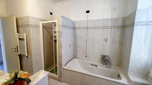a bathroom with a bath tub and a shower at UN BALCONE IN PINETA in Fezzano