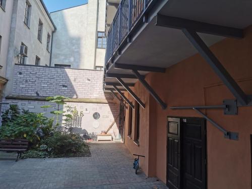 an alley between two buildings with a bike parked next to it at Town Square Apartment in Lublin
