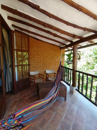 a hammock on the porch of a house at Casona CHARA in Barichara