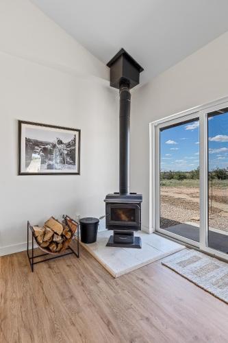 a living room with a stove and a window at The Grand Canyon Headquarters in Valle