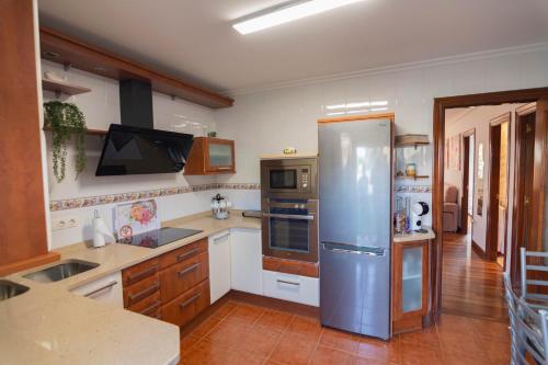 a kitchen with a stainless steel refrigerator in it at APARTAMENTO COSTA CANTABRIA in Cuchia