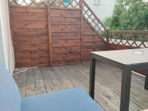 a wooden deck with a table and a wooden fence at Apartments Blanca in Vodice
