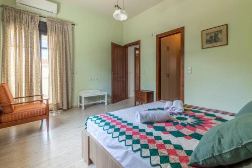 a bedroom with a large bed and a chair at 50 steps from the sea. in Gournes