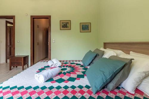 a bedroom with a large bed with pillows on it at 50 steps from the sea. in Gournes