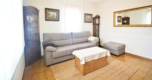 ein Wohnzimmer mit Sofa und Tisch in der Unterkunft GALIHOST - Casa con jardín en Cambados in Cambados