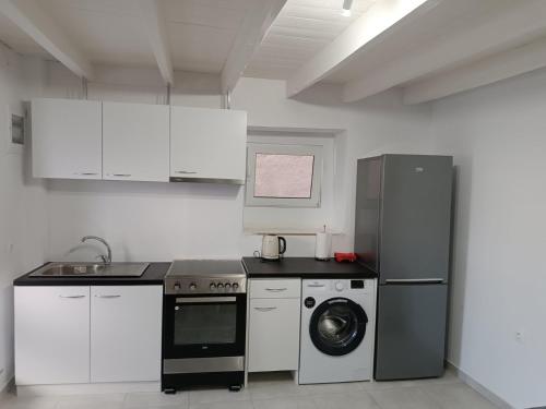 a kitchen with a refrigerator and a washing machine at Sunrise Apartments - Aegean Blue in Kalymnos