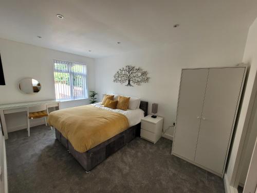 a bedroom with a bed and a dresser in it at Yew Tree Cottage- A beautiful cottage with Hot Tub in Hintlesham