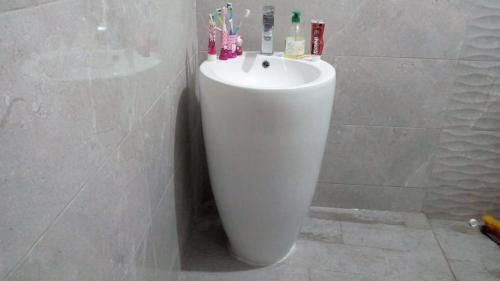 een badkamer met een witte wastafel in een muur bij Appartement 05 in Temara