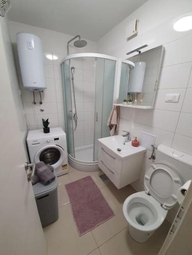 a bathroom with a toilet and a shower and a sink at Apartman Mila in Split