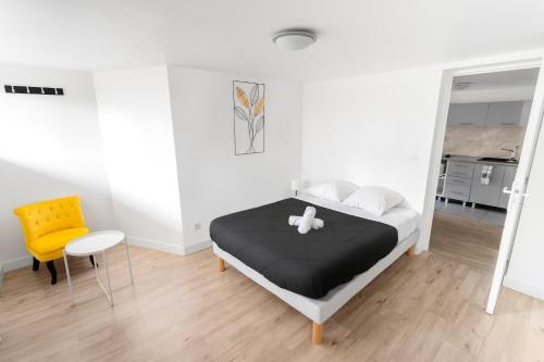 1 dormitorio con 1 cama y 1 silla amarilla en Suite 1 &2 Joubert de Lily, en Villiers-sur-Marne