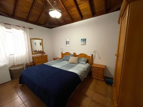 ein Schlafzimmer mit einem blauen Bett in einem Zimmer in der Unterkunft VV Casa Carmela Talavera in Barlovento