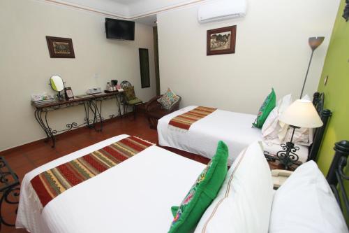 Katil atau katil-katil dalam bilik di Hotel Boutique Parador San Miguel Oaxaca