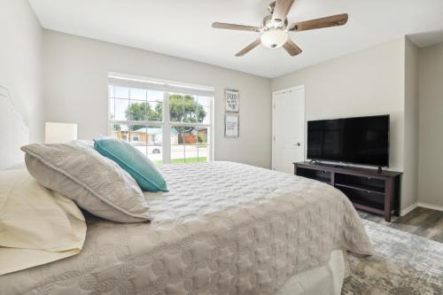 a bedroom with a bed and a flat screen tv at Spacious San Antonio Retreat with Private Patio! in San Antonio