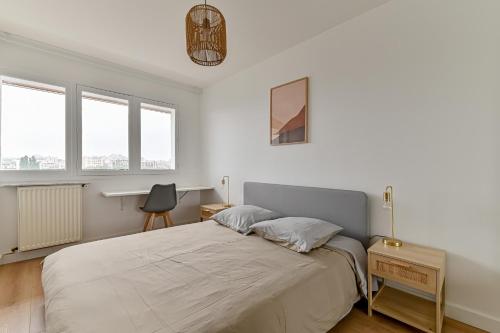 a bedroom with a large bed with white walls and windows at CityStay full brand new appartement 3 bedrooms 5min to Paris in Bagnolet
