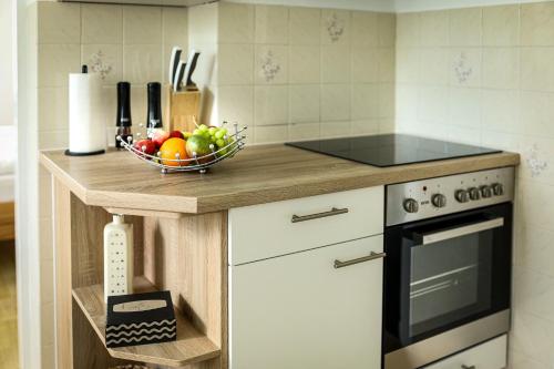a kitchen with a bowl of fruit on a counter at Panoramablick Scheifling in Lind bei Scheifling