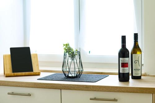 two bottles of wine and a vase on a counter at Panoramablick Scheifling in Lind bei Scheifling