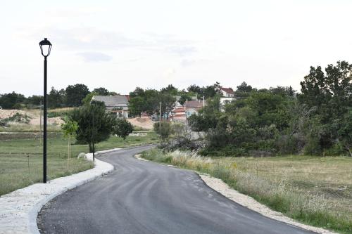 a winding road with a street light on the side at Great place for relaxation in Gornji Proložac